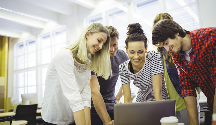 Group-of-business-executives-using-laptop-at-their-desk